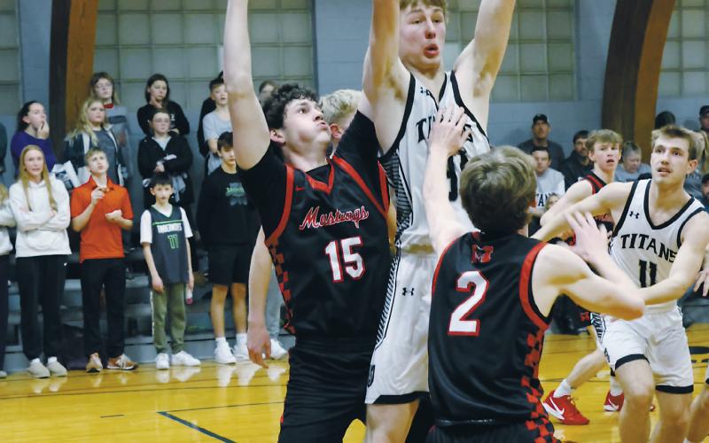 Under heavy defense from Midway-Minto's Andrew Riske and Elijah Robinson, DVE's Jack Langerud looks to save the ball. Photo by Jamie Rarick