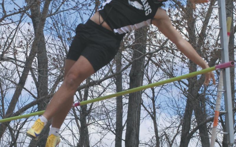 Clearing the bar, DVE junior Carter Johnson flies through the air during the Mens Pole Vault competition, ending with a first place finish at a height of 10' 6'. Photo by Jamie Rarick