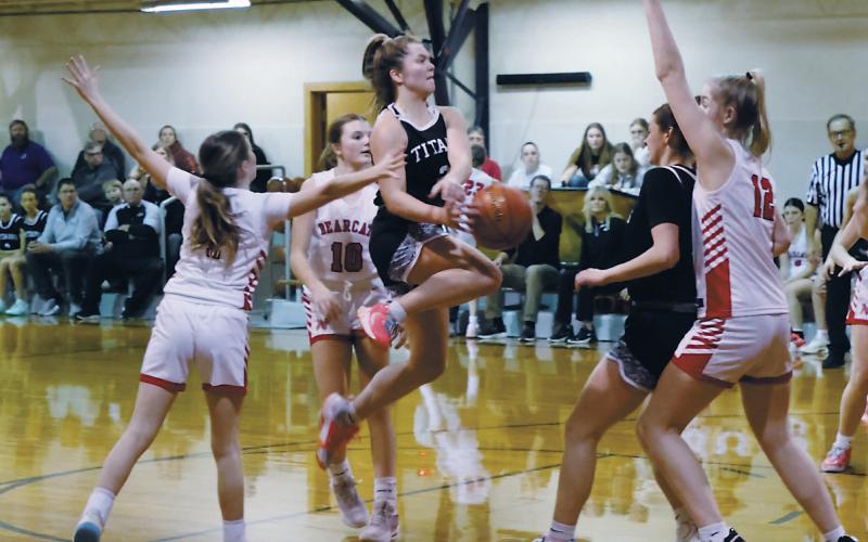 Leaping in the air, DVE senior Brooke Gullickson tries to save the ball from North Star defenders. Photo by Jamie Rarick