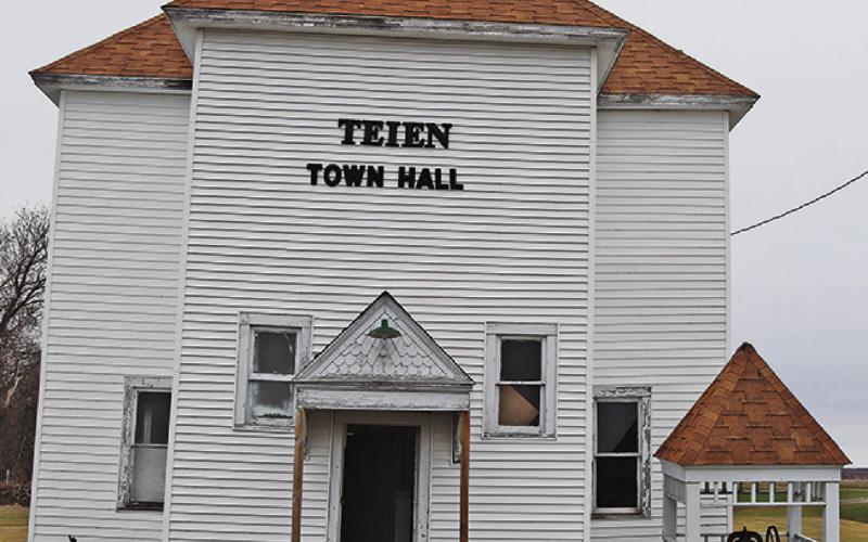 The Teien Town Hall as it currently stands with the bell tower carefully placed on the ground next to the building in an effort to save both the bell and the roof. VNV Photo by Lesa Van Camp