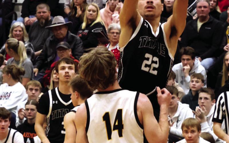 DVE junior Mason Pollestad goes for the basket over Park River defender Luke Shirek. Photo by Jamie Rarick