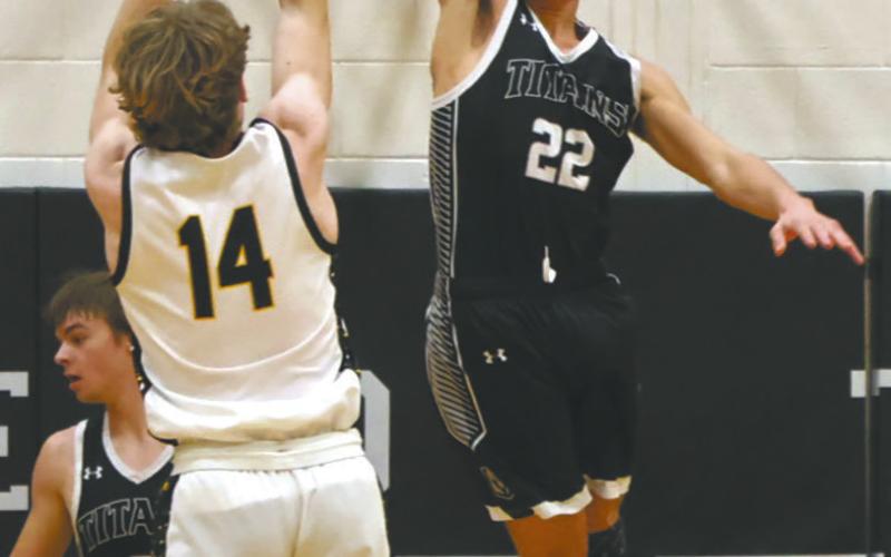 Park River's Luke Shirek attempts the shot, but is blocked by DVE's Mason Pollestad. Photo by Jamie Rarick Students cheer on the Titans at the Region 2B Tournament in Devils Lake Monday night. Photo by Larry Stokke