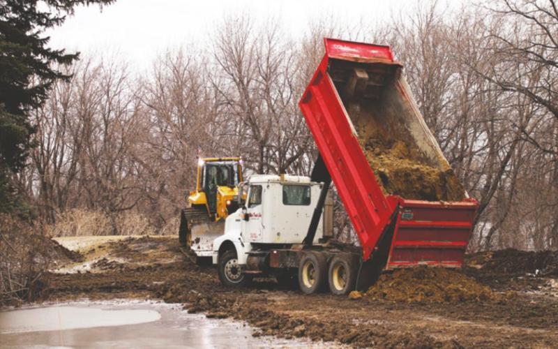 Helm Enterprises began building the temporay dikes here on Monday. Pictured is work near the city water plant Monday afternoon. VNV photo by Lyle Van Camp