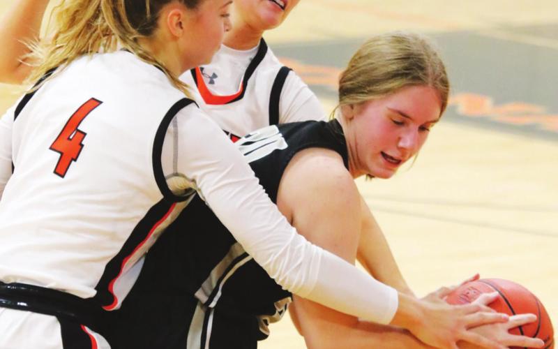 Kiara Aasand tries to fight through two Cavalier defenders. VNV photo by Lyle Van Camp