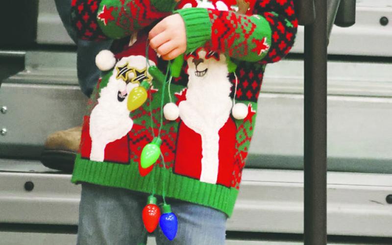 Elliott Thompson wore his ugly sweater and Santa Hat to the game last Friday evening. Photo by Lyle Van Camp.