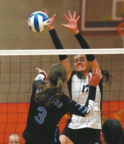 Senior Elizabeth Fedje goes for the block. Photo by Larry Stokke.