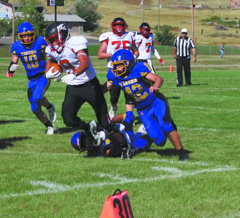#9 Mason Pollestad drags defenders to make a big gain. Photo by Jamie Rarick