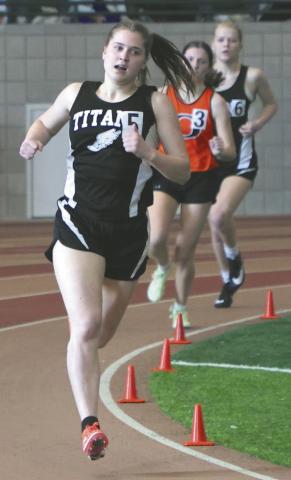 Greta Burrell and Alyssa Hoyles sandwich another runner in the Girls 300.