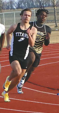 Fighting through the wind and cold, sprinters, including DVE junior Trenten Keena, rounded the track during the Mens 200m dash. Keena earned a 7th-place finish in the competitive event. Photo by Jamie Rarick