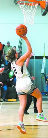Brooke Gullickson goes for a layup in play against the Mustangs. Photo by Larry Stokke.