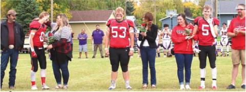 The Bombers Seniors and their parents were introduced at the start of the New Town game. From the left; Juan and Jessie Navarro and Gavin Ryan; Bryce Wimpfheimer and his mother Kristi Wimpfheimer; Maggie Vold, Grant Vold, and Matt Vold.