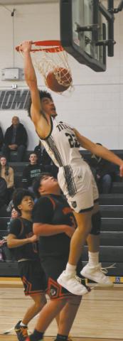 Sprinting down the court, DVE's Mason Pollestad wows the crowd with an impressive dunk. Photo by Jamie Rarick
