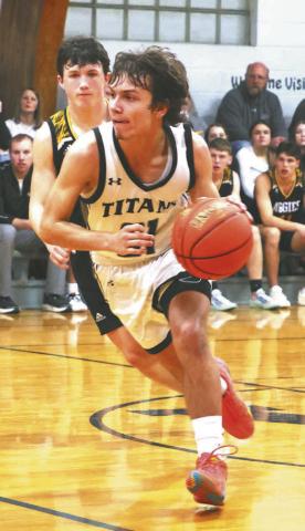Trenten Keena brings the ball up the court in action against Park River.
