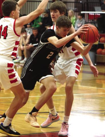 Quinn Passa fights his way through two North Star defenders.