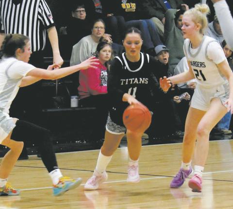 MORE SPORTS PAGE 2 Jacey Nelson splits through the Nelson County defenders on her way towards the basket. Photo by Jamie Rarick