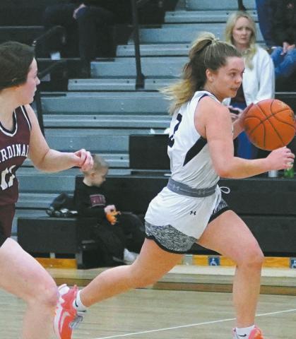 Brooke Gullickson hustles the ball up the court against Langdon defender Erika Bakke. Photo by Larry Stokke.