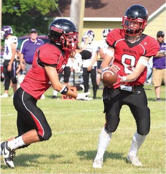 Trenton Keena receives a handoff from Gavin Ryan. Photo by Lyle Van Camp.