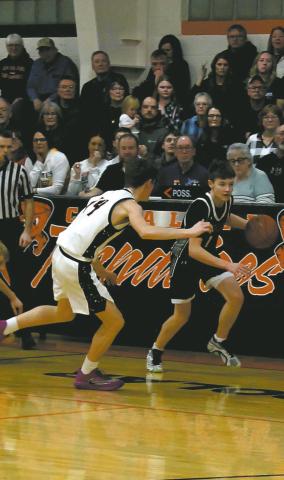 DVE Senior Drew Passa drives down the court past the Cavalier defense. Photo by Jamie Rarick