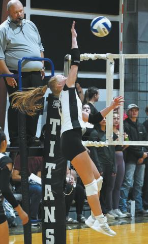 Peyton Larson slams the ball over the net in the match versus Park River. Photo by Larry Stokke