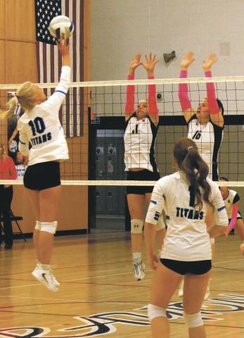 Alyssa Hoyles and Ingrid Myrdal leap into the air in an attempt to block a Griggs Midkota hit. Photo by Jamie Rarick