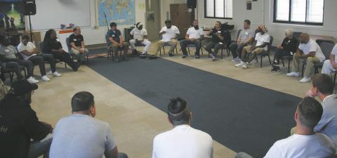 North Dakota DOCR Director Colby Braun joins Shining Light staff and the first Academy cohort at Missouri River Correctional Center — to reflect on the journey and the impact the program has in their lives. Photo provided by Shining Light.