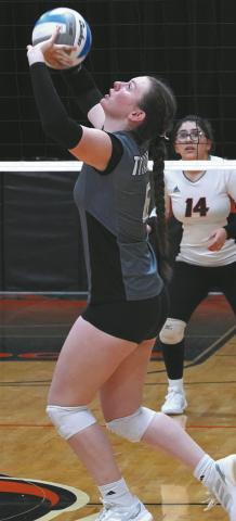 Taylor Hermanson sets the ball to a teammate in the Titans win over Cavalier. Photo by Larry Stokke