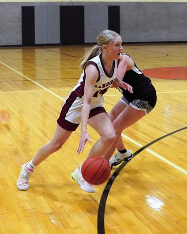 Editor’s note: This is the final year of educational instruction for Edmore Public School. Tip off for the very last game on Edmore’s home court was at 7 p.m. on Thursday, Jan. 25 when the Langdon-Edmore-Munich girls basketball team played one last game at the school against Drayton-Valley-Edinburg. Hilary Haaven drives around D-VE’s Greta Burrell at Edmore gym’s final game. Photo by Larry Stokke.