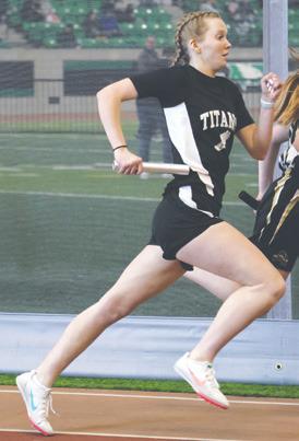 Easton Larson running a leg of the girls’ 4 x 300 relay. Photo by Lyle Van Camp.