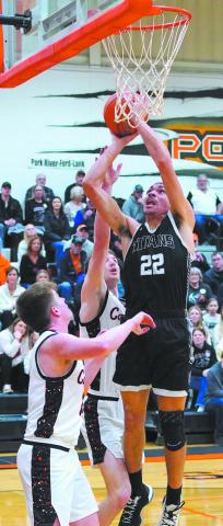 Mason Pollestad goes for the dunk during play against Cavalier in the District 3 tournament action. Photo by Larry Stokke