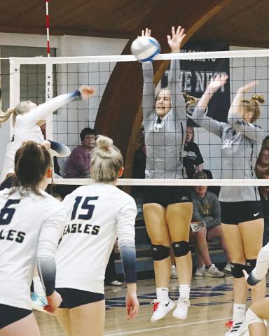 Emily Gonzalez and Claire Thompson both go for a dig against the NB Eagles. Photo by Larry Stokke Kiara Assand with a stuff block against the North Border Eagles . Photo by Larry Stokke.