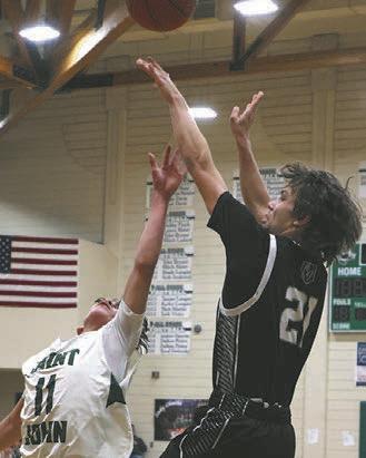 Trenten Keena shoots over St. John's Ashton Parisien at the boys play-in game on Saturday.