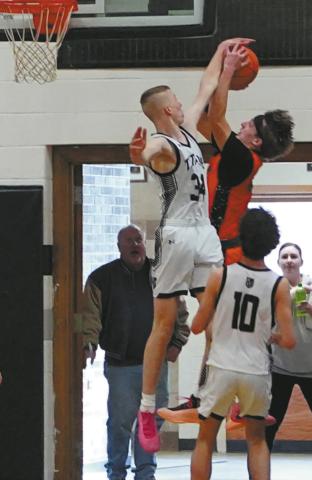 Jack Langerud gets his hand on Breckon Thorpe’s shot for a nice block against Cavalier in Edinburg on Jan. 6. Photo by Larry Stokke