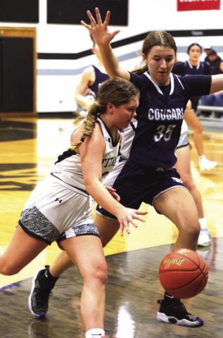 Brooke Gullickson drives past North Prairie's Morgan Casavant.