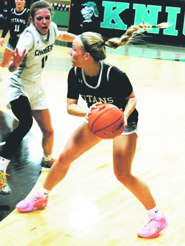 Reese Fering looks to move the ball past Charger defender Cara Sateren. Photo by Jamie Rarick