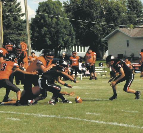 Bomber defenders Trenten Keena and Lucas De Souza dive for a Warwick fumble. Photo by Jamie Rarick