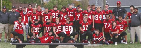 The Bombers players and coaches possed for photos after winning their semi-final game last Saturday. Photo by Lyle Van Camp