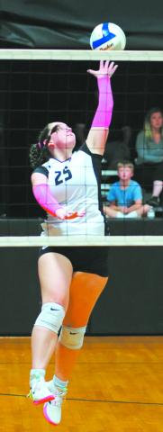 DVE senior Christine O'Toole extends for the spike. Photo by Larry Stokke.