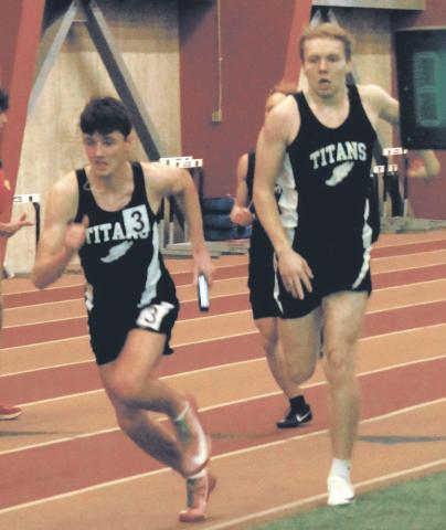 The baton is handed from Carter Oberg to anchor Brady Reilly to finish the 4x300 relay. The team finished 1st with a new school record of 2:36.56. Photo by Jamie Rarick
