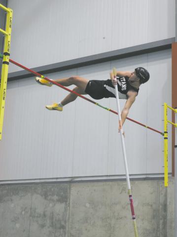 DVE junior Carter Johnson clears the bar in pole vault, winning the meet with a personal best of 11' 3'. Photo by Jamie Rarick