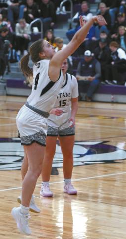 Gretta Burrell sinks a long three point shot against the NP Cougars. Photo by Larry Stokke