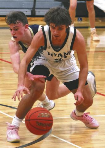 Trenten Keena fights off an attempted steal by a North Border defender.