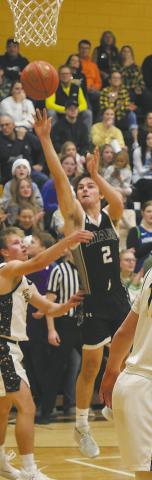 DVE junior Teddy Otto goes for the shot over an Aggie defender. Photo by Jamie Rarick