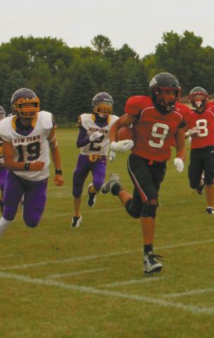 Mason Pollestad outruns the Eagle defense for another Bomber touchdown gainst New Town. Photo by Jamie Rarick.