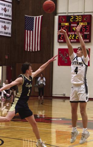 Charles Kittelson shoots over North Border’s Kaden Moore.