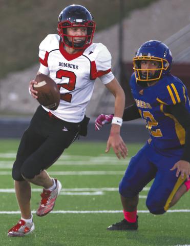 Quinn Passa looks for an open receiver. Photo by Lyle Van Camp