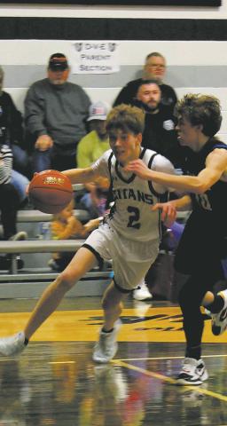 DVE senior Quinn Passa drives past a Griggs-Midkota's defender in Edinburg Feb. 8. Photo by Jamie Rarick