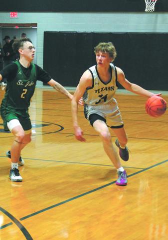 DVE's Jack Langerud moves the ball down the court past St. John's Madden Parisien.