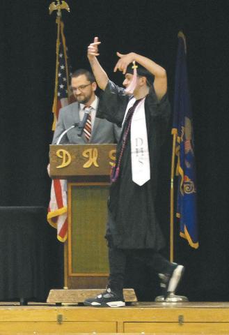 Senior Trypp Castillo doing a happy dance on his way to receive his diploma. Photo by Andrea Johnston