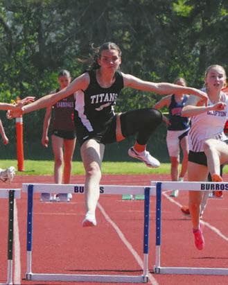 Elizabeth Fedje hurdling herself to first place. Photo by Larry Stokke.
