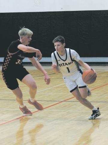 Mustang defender Marek Osowski guards Titan Drew Passa as he moves the ball down the Drayton court Feb. 6. Photo by Jamie Rarick